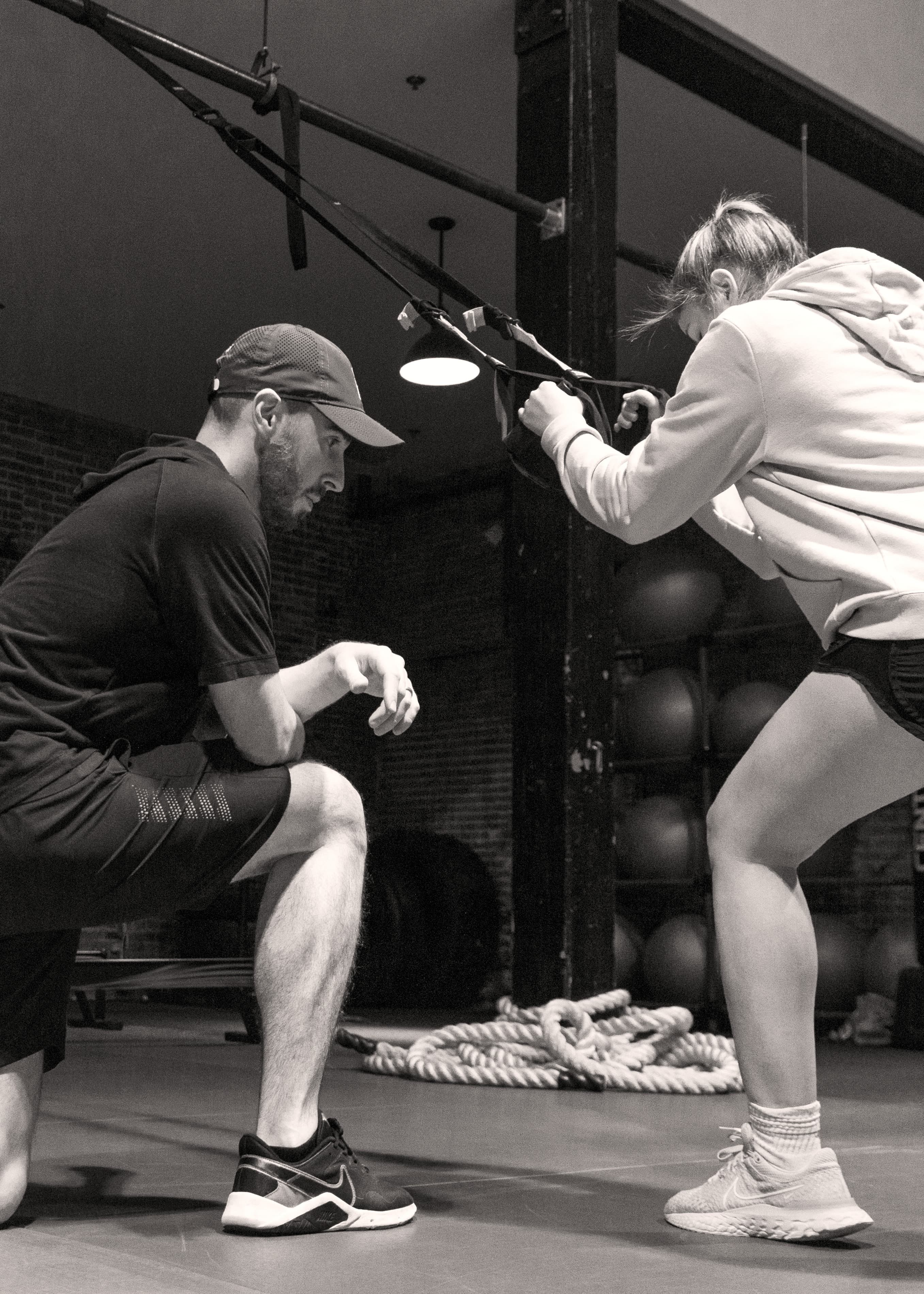 Personal trainer working with client