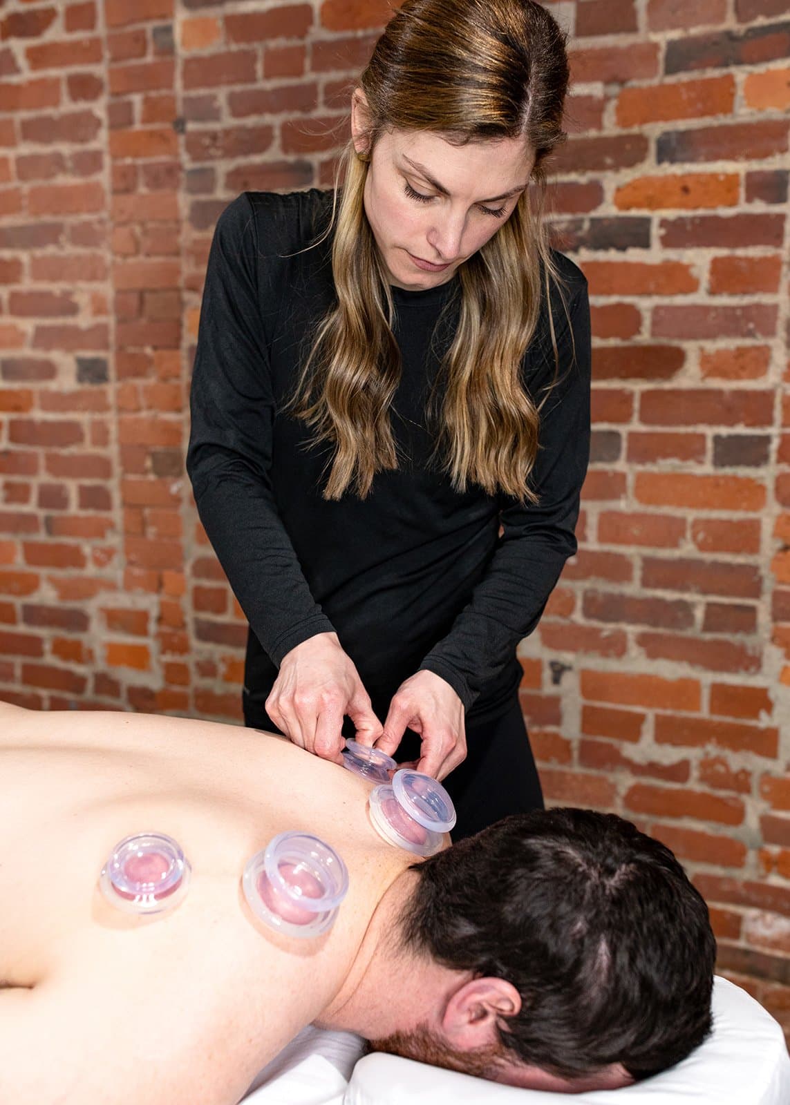 Dr. Molly performing IASTM & Cupping